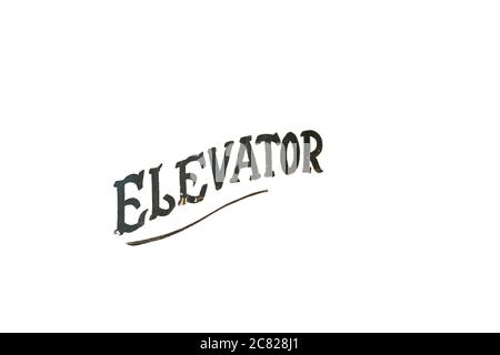 Old Fashioned and Worn Black Text That Says Elevator on a Pure White Background Stock Photo