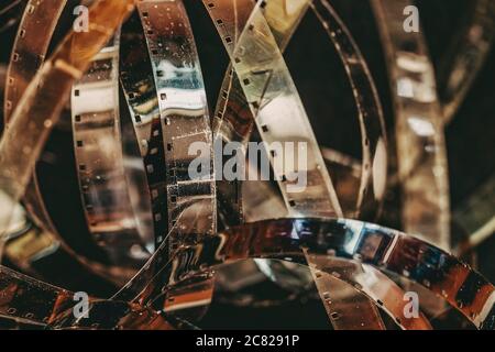 vintage movie camera lies against the background of reels with