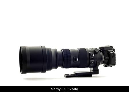 Horizontal shot of a modern DSLR camera with super telephoto zoom lens on a white background. Stock Photo