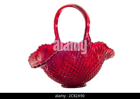 Horizontal side view shot of a beautiful old red glass basket with a handle.  Shot on a white background. Stock Photo