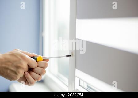 The man is repairing the plastic window Stock Photo