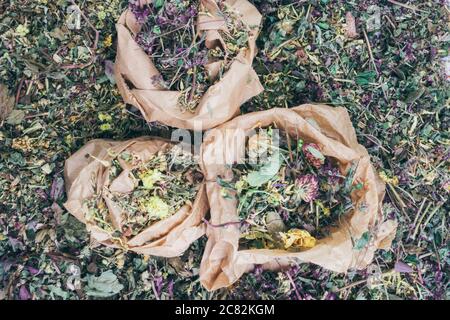 mix of healing herbs in eco zero waste paper bags, close up, herbal medicine, top view. Flat lay. Stock Photo