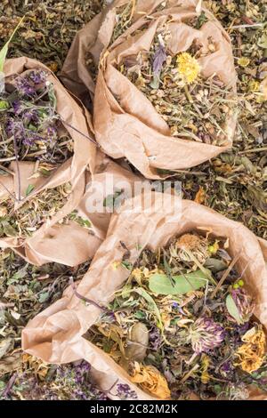 mix of healing herbs in eco zero waste paper bags, close up, herbal medicine, top view. Flat lay. Stock Photo