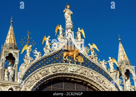 Basilica of Saint Mark or San Marco close-up, beautiful rooftop in blue sky, Venice, Italy. Old cathedral is top landmark of Venice. Facade of medieva Stock Photo