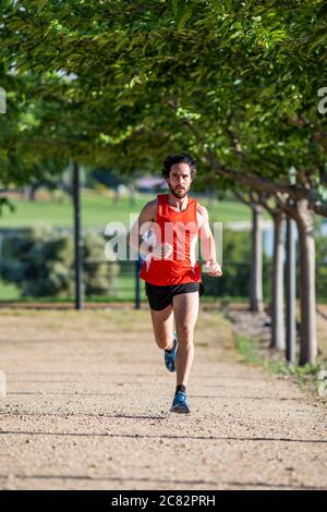 young man running in the city park Stock Photo