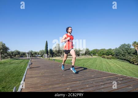 young man running in the city park Stock Photo