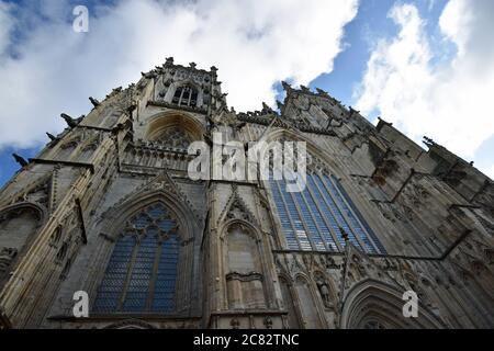 Looking directly upwards at the Western Towers of York Minster creating an abstract and dramatic look.  Clouds fill the sky.  Yorkshire, England. Stock Photo
