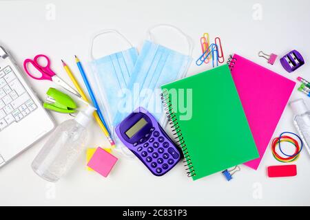 School or office supplies and coronavirus prevention items. Flat lay on a white background. Stock Photo