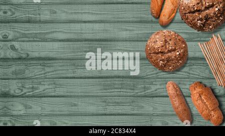 Bread on a wooden background with copy space. Different types of breads. Isolated breads. Stock Photo