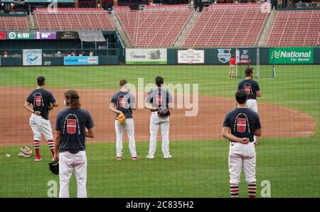 Several St. Louis Cardinals players stand for the National Anthem before a  game against the Milwaukee Brewers in high socks at Busch Stadium in St.  Louis on May 19, 2013. The team