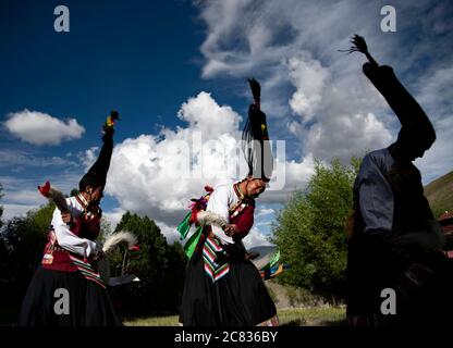 (200721) -- BEIJING, July 21, 2020 (Xinhua) -- Apprentices of Nyima perform Jiuhe Zhuo dance in Jiuhe Village of Qonggyai County in Shannan, southwest China's Tibet Autonomous Region, July 1, 2020. Jiuhe Zhuo dance, originated in Qonggyai County of Shannan, has a history of more than 1,300 years. It has been a favorite dancing form for local people in Shannan to pray for good luck since ancient times and was dubbed waist drum dance in Tibet. Nyima, an inheritor of Jiuhe Zhuo dance, which is a national intangible cultural heritage, began to learn the dance from his father at the age of nine an Stock Photo