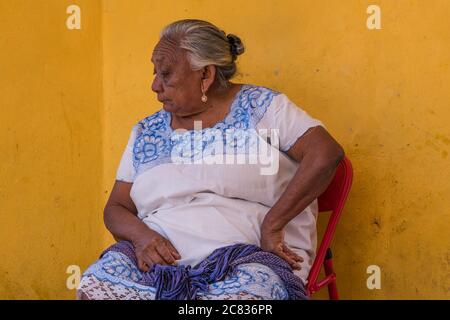 A Mayan woman in a traditional embroidered huipil in Izamal, Yucatan, Mexico, known as the Yellow Town.  The Historical City of Izamal is a UNESCO Wor Stock Photo