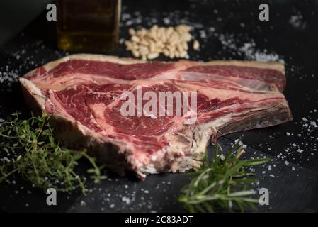 Shallow focus shot of a raw steak seasoned and ready to be cooked Stock Photo