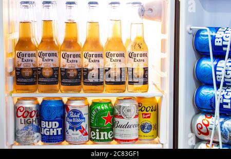 Calgary, AB, Canada. July 20, 2020. Corona beer bottles and Various craft beer cans, domestic and imported beers from around the world on a mini fridg Stock Photo