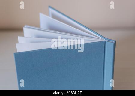 Side view of photobook on white wooden table Stock Photo