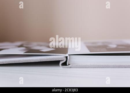Buttom view of open photobook on white wooden table Stock Photo - Alamy