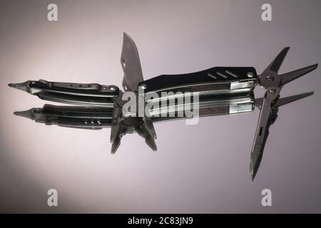 grey swiss knife isolated on white background Stock Photo