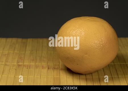 One grapefruit on a bamboo background Stock Photo