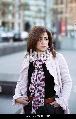 Serious Middle Eastern standing outdoors looking away Stock Photo
