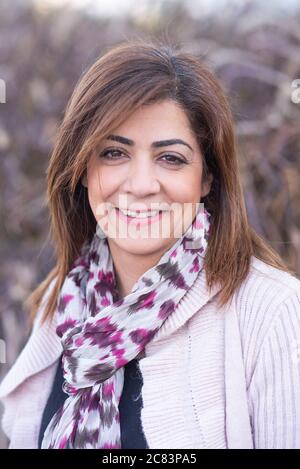 Happy middle eastern woman looking at camera smiling Stock Photo