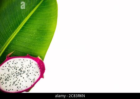 Dragon fruit on a banana leaf isolated on white background. Stock Photo