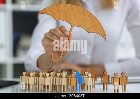 Businesswoman developing company strategy by using wooden figures Stock Photo