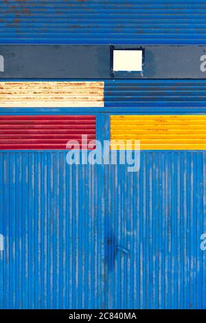 Iron metal gate with colored painted rectangles Stock Photo