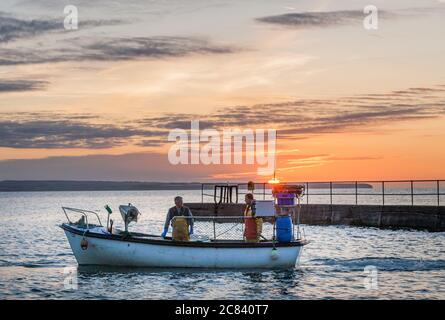 Knockadoon, Cork, Ireland. 21st July, 2020. Father and son  Barney and Vincent O'Brien depart at sunrise for a day fishing at Knockadoon, Co. Cork, Ireland. - Credit; David Creedon / Alamy Live News Stock Photo