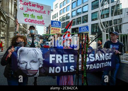 London, UK.  21 July 2020. Supporters of Julian Assange in attendance as Dame Vivienne Westwood is being harnessed into a giant birdcage and suspended 10 feet in the air in front of The Old Bailey Criminal Court in protest about the U.S. extradition trial of Julian Assange, which is to recommence at the Old Bailey on 7 September.  She is dressed in a yellow trouser suit, enacting the metaphor of ‘The Canary In Coal Mine’, which is indicative of 'Assange being sacrificed for identifying ‘poison’ in the system'.   Credit: Stephen Chung / Alamy Live News Stock Photo