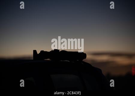 A camera is set up on a  car roof in the dark night Stock Photo