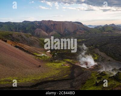 Colorful Rhyolit mountain panorma with multicolored volcanos and geothermal fumarole and in Landmannalaugar area of Fjallabak Nature Reserve in Stock Photo