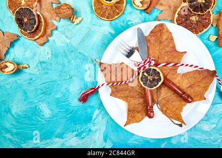 Autumn or Fall table place setting decorated with autumnal leaves. Stock Photo