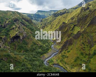 Landscape of Godland and thorsmork with rugged green moss covered rocks and hills, bending river canyon, Iceland, Fimmvorduhals hiking trail. Summer Stock Photo