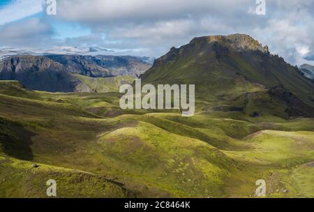 Breathtaking view on Landscape of Godland and thorsmork with rugged green moss covered hill and Eyjafjallajokull glacier, Iceland, Fimmvorduhals Stock Photo