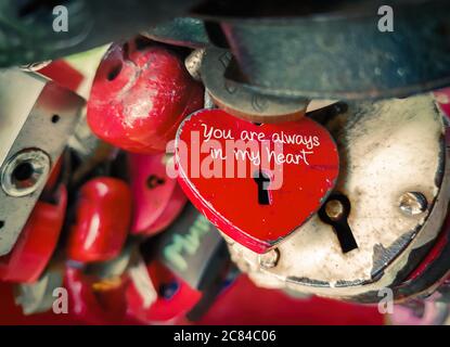 Heart shaped padlock among many locks. Valentine or love concept. Stock Photo