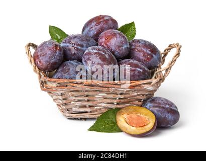 Fresh plums with leaves isolated on white Stock Photo