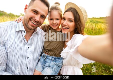 Happy loving family taking selfie on a picnic outdoor Stock Photo