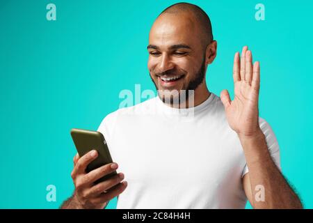 Young african american man making video call with his smartphone Stock Photo