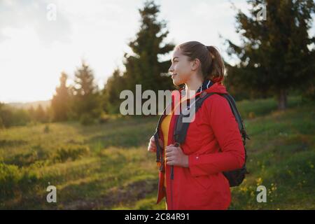 Young woman on a walk outdoors on meadow in summer nature, walking. Stock Photo