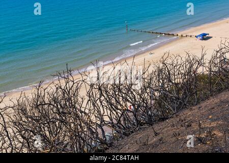Bournemouth, Dorset UK. 21st July 2020. Aftermath of fire at West Cliff beach, Bournemouth which started in beach hut, showing charred remains of cliffside behind.  Credit: Carolyn Jenkins/Alamy Live News Stock Photo