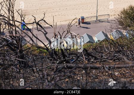 Bournemouth, Dorset UK. 21st July 2020. Aftermath of fire at West Cliff beach, Bournemouth which started in beach hut, showing charred remains of cliffside above beach huts.  Credit: Carolyn Jenkins/Alamy Live News Stock Photo