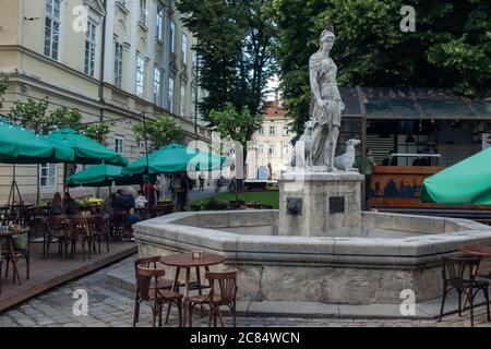 Lviv city, Ukraine, July 2020. Fountain and statue of Diana with dogs in the central square of the city. Tourism concept during quarantine. Stock Photo