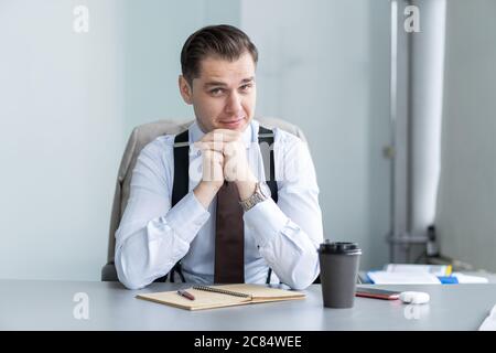 Smiling businessman sit at desk talk on webcam having videocall with client, motivated coach speak shoot online tutorial Stock Photo