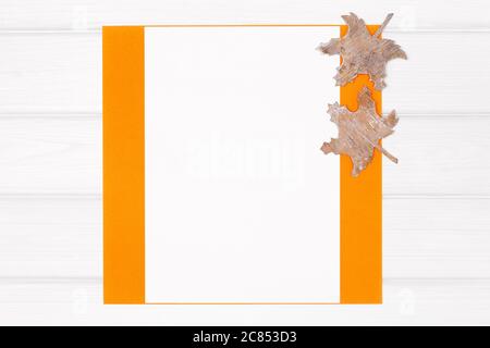 Minimal flat lay autumn frame with bark maple leaves on white wooden board background. Fall season vertical mockup composition Stock Photo