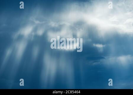 Sun rays break through the stormy clouds. Stock Photo