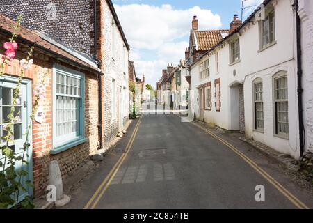 The narrow High Street in the village of Blakeney Norfolk UK Stock Photo