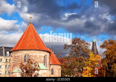 Nuremberg Johannisfriedhof Cemetery in the Autumn . Scenery with church and colorful trees Stock Photo