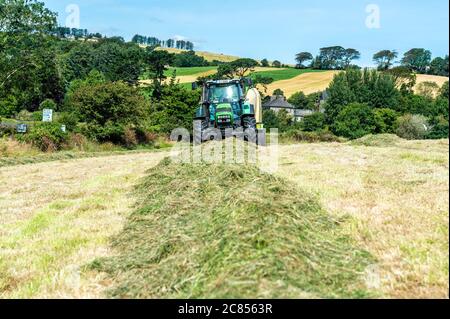 Timoleague, West Cork, Ireland. 21st July, 2020. On a day of hot, sunny weather and highs of 22 degrees Celsius, Michael and Richard McCarthy bale silage on their farm in Timoleague, West Cork. Credit: AG News/Alamy Live News. Stock Photo