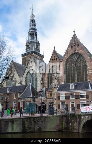 Amsterdam, Netherlands - January 15 2019: The old church of Oude Kerk in the centre of the De Wallen Red Light District of Amsterdam. Stock Photo
