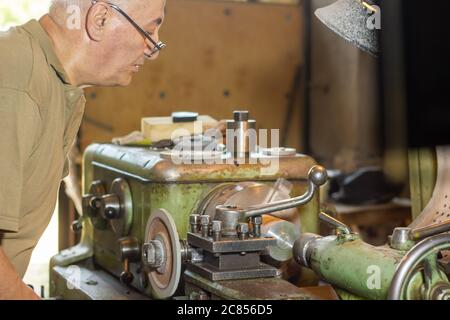 man working on machine in a factory